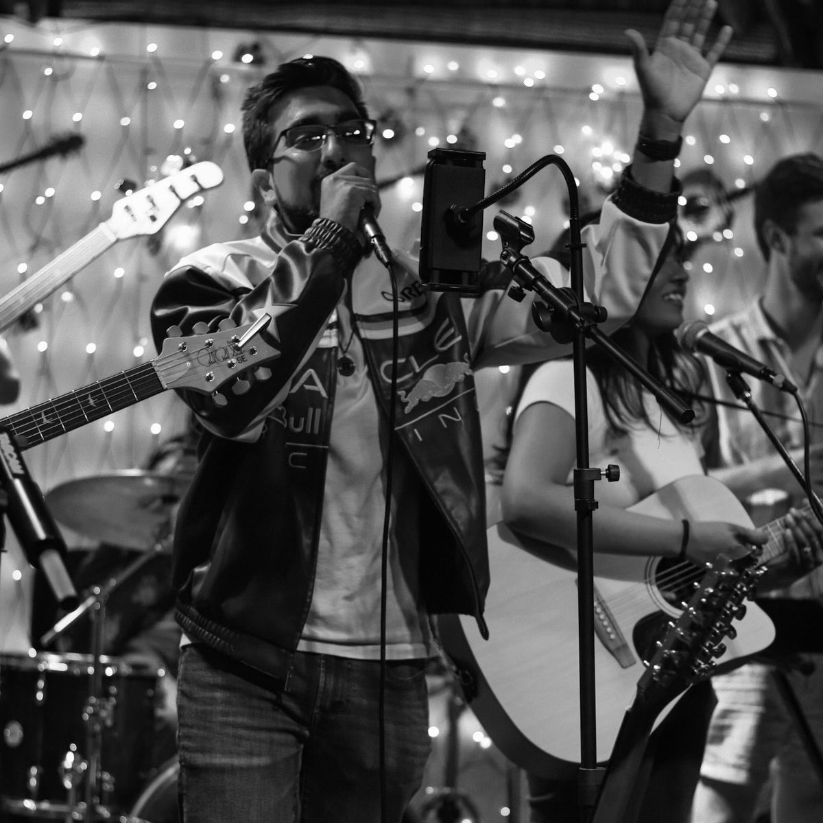 Always Tired playing live, vocalist at the microphone with the band behind